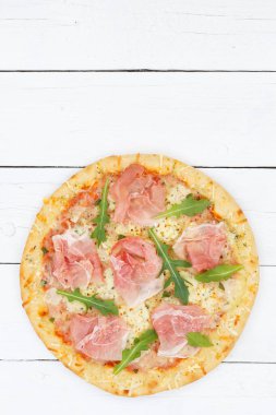 Ham pizza prosciutto from above copyspace copy space portrait format on wooden board wood
