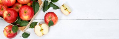 Apples apple fruits fruit with leaves from above banner copyspace copy space wooden board wood