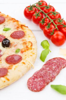 Pizza pepperoni salami baking ingredients portrait format on wooden board wood