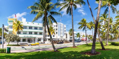 Miami Beach, United States - November 15, 2022 Ocean Drive with hotels in Art Deco architecture style panorama in Miami Beach Florida, United States. clipart