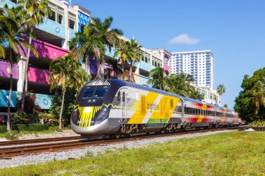 West Palm Beach, United States - November 14, 2022 Brightline private inter-city rail train in West Palm Beach in Florida, United States. clipart