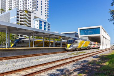 West Palm Beach, United States - November 14, 2022 Brightline private inter-city rail train at West Palm Beach railway station in Florida, United States. clipart