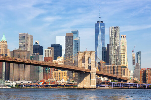 New York City skyline of Manhattan with Brooklyn Bridge and World Trade Center skyscraper traveling in the United States