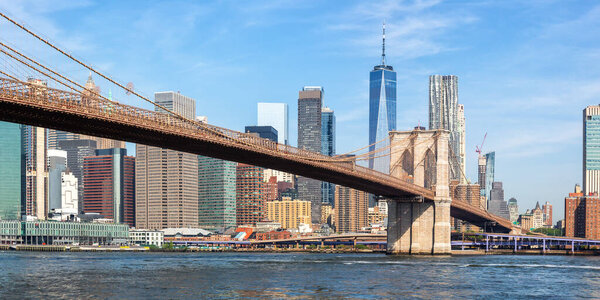 New York City skyline of Manhattan with Brooklyn Bridge and World Trade Center skyscraper traveling panorama in the United States