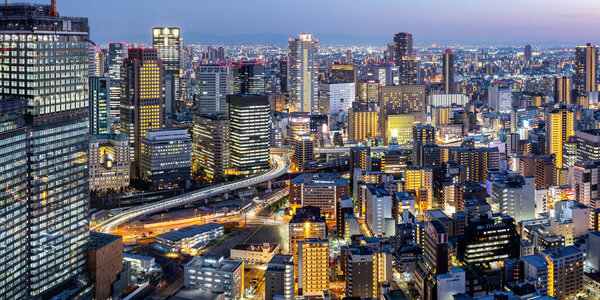 Osaka big city lights from above skyline with skyscraper panorama town at twilight in Japan