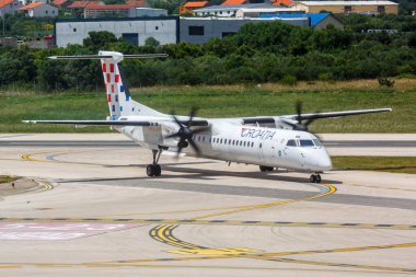 Split, Croatia - June 1, 2023: Croatia Airlines De Havilland Canada Dash 8 Q400 airplane at Split Airport (SPU) in Croatia. clipart