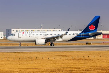 Beijing, China - March 31, 2024: Qingdao Airlines Airbus A320neo airplane at Beijing Daxing Airport (PKX) in China. clipart