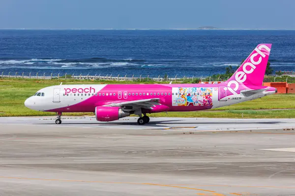 stock image Naha, Japan - October 3, 2023: Peach Airbus A320 airplane with Soaring Sky Pretty Cure special livery at Okinawa Naha Airport (OKA) in Japan.