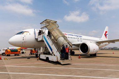 Shanghai, China - April 11, 2024: First aircraft developed entirely in China COMAC C919 of China Eastern at Hongqiao Airport (SHA) in Shanghai, China. clipart