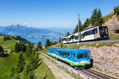 Passenger railway train type Stadler Flirt of Sudostbahn at Grosser Mythen mountain in the Swiss Alps in Arth, Switzerland clipart