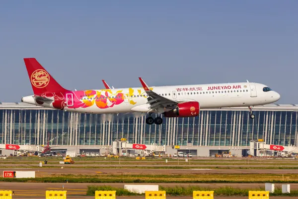 stock image Shanghai, China - April 10, 2024: Juneyao Air Airbus A321neo airplane at Shanghai Pudong Airport (PVG) in China.