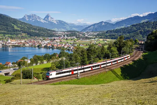 stock image Passenger train of Schweizerische Bundesbahnen SBB railway at Grosser Mythen mountain at Lake Zug in the Swiss Alps in Arth, Switzerland