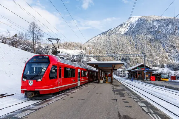 stock image Filisur, Switzerland - January 10, 2024: Rhaetian Railway passenger train on Albula line by Stadler Rail type Capricorn at train station in Filisur, Switzerland.