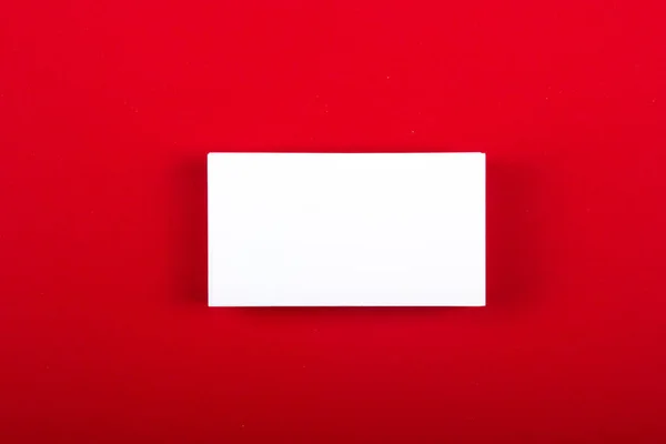 Blank business cards at red textured background. Template for ID. Top view