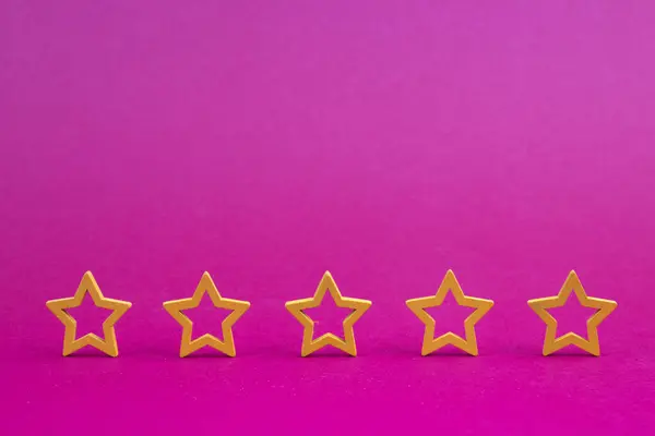 Gold, gray, silver five stars shape on a purple background. The best excellent business services rating customer experience concept. Concept image of setting a five star goal