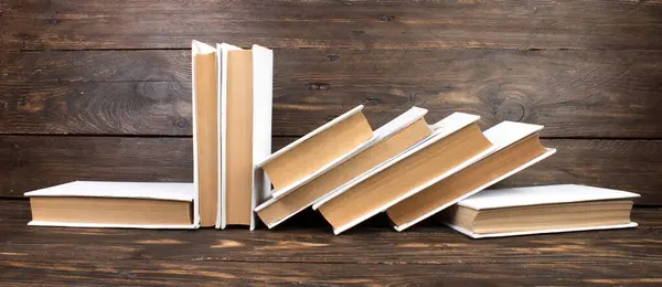 Stack of white books. Education background. Back to school. Book, hardback books on wooden table. Education business concept. Copy space for text