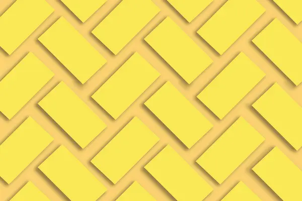 Mockup of stacks of gold business cards arranged in rows on a yellow textured paper background