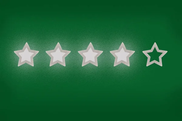 Gray, silver five star shape on a green background. The best excellent business services rating customer experience concept. Increase rating or ranking, evaluation and classification idea