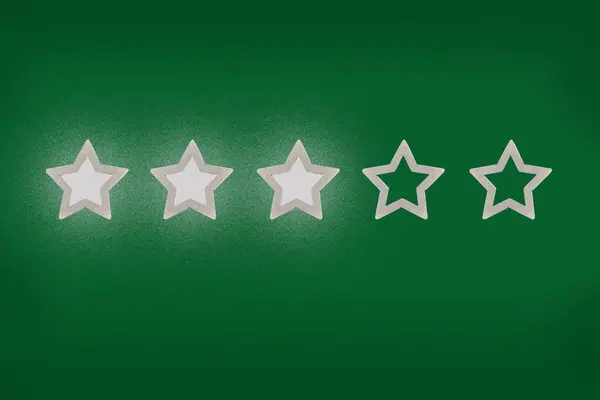Gray, silver five star shape on a green background. The best excellent business services rating customer experience concept. Concept image of setting a five star goal.