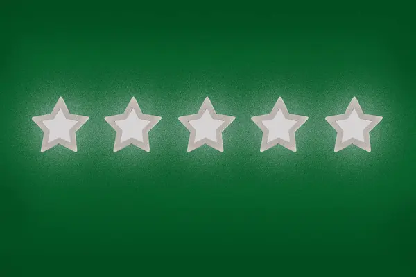 Gray, silver five star shape on a green background. The best excellent business services rating customer experience concept. Concept image of setting a five star goal.