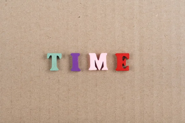 TIME word on background composed from colorful abc alphabet block wooden letters, copy space for ad text. Learning english concept