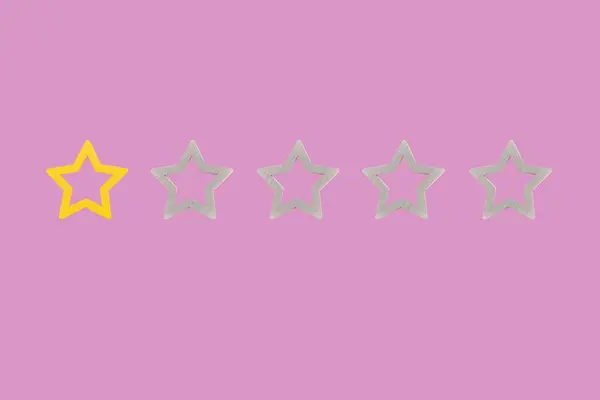 Gold, gray, silver five star shape on a pink background. The best excellent business services rating customer experience concept. Concept image of setting a five star goal.