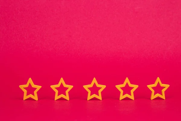 Gold, gray, silver five stars shape on a red background. The best excellent business services rating customer experience concept. Concept image of setting a five star goal