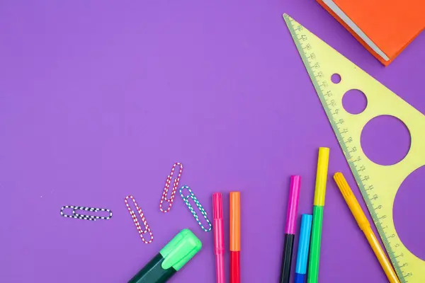Back to school. Stationery on a Purple table. Office desk with copy space. Flat lay