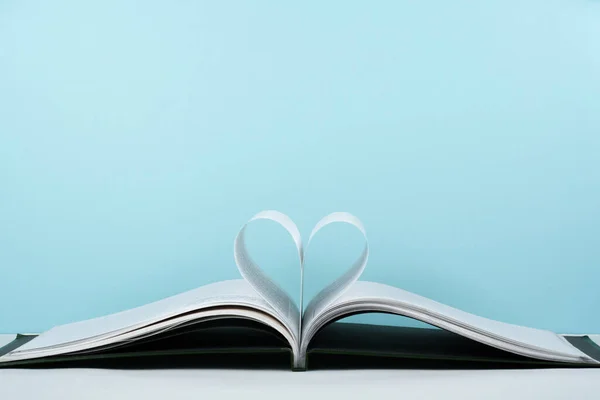 Old open hardback book, page decorate into a heart shape for love in Valentine\'s. love with open book heart