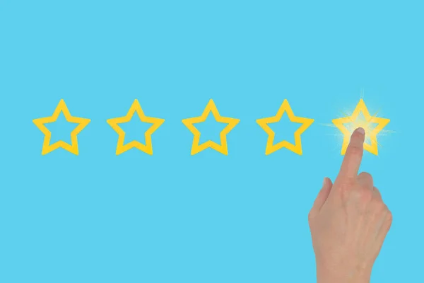 A woman\'s hand leaves a rating of five stars out of five on a blue background. Highest rating. Get a fifth star.