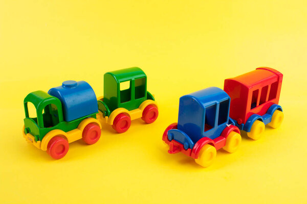 Children's toy, a multi-colored steam locomotive on a yellow background. For the development of the child.