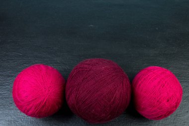 Siyah arka planda örgü örmek için iplik örüyorum.