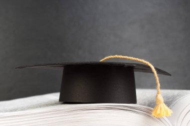 Ahşap güverte masası ve kara tahta arka planı üzerine açık bir kitap. Okula geri dön. Reklam metnin için kopyalama alanı olan eğitim kavramı