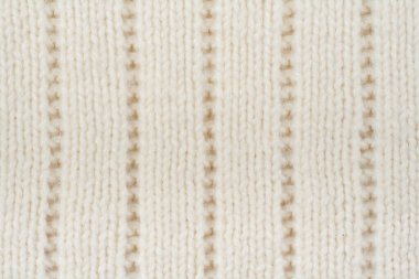 Süveter ya da atkı kumaş dokusu büyük örgü. Örülmüş forma ve kabartma desenli. Yün el yapımı makine, el yapımı.