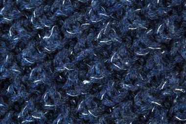 Süveter ya da atkı kumaş dokusu büyük örgü. Örülmüş forma ve kabartma desenli. Yün el yapımı makine, el yapımı.
