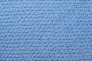 Süveter ya da atkı kumaş dokusu büyük örgü. Örülmüş forma ve kabartma desenli. Örgü ören örgüler. Yün el yapımı makine, el yapımı..