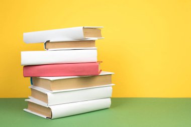 Kitap istifleme. Ahşap masa ve yeşil arka plan açık ciltli kitap. Okula dönüş. Kopya alanı reklam metni için