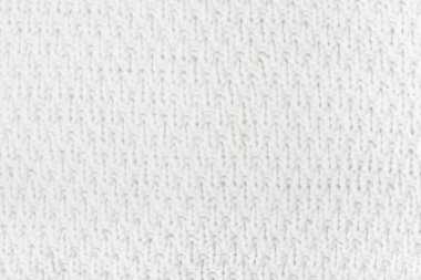 Süveter ya da atkı kumaş dokusu büyük örgü. Örülmüş forma ve kabartma desenli. Yün el yapımı makine, el yapımı.