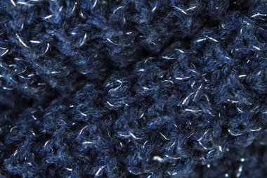 Süveter ya da atkı kumaş dokusu büyük örgü. Örülmüş forma ve kabartma desenli. Yün el yapımı makine, el yapımı.