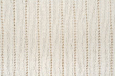 Süveter ya da atkı kumaş dokusu büyük örgü. Örülmüş forma ve kabartma desenli. Örgü ören örgüler. Yün el yapımı makine, el yapımı..