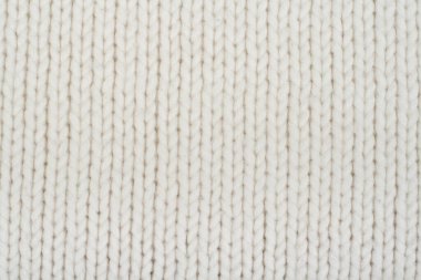 Süveter ya da atkı kumaş dokusu büyük örgü. Örülmüş forma ve kabartma desenli. Yün el yapımı makine, el yapımı.