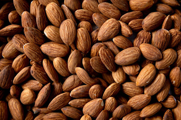 A closeup photo of a large pile of Almonds.