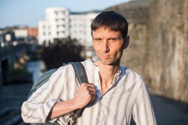 Neşeli, orta yaşlı, neşeli bir adam. Dışarıda güneşli bir günde.