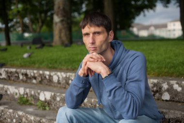 Neşeli, orta yaşlı, neşeli bir adam. Dışarıda güneşli bir günde.