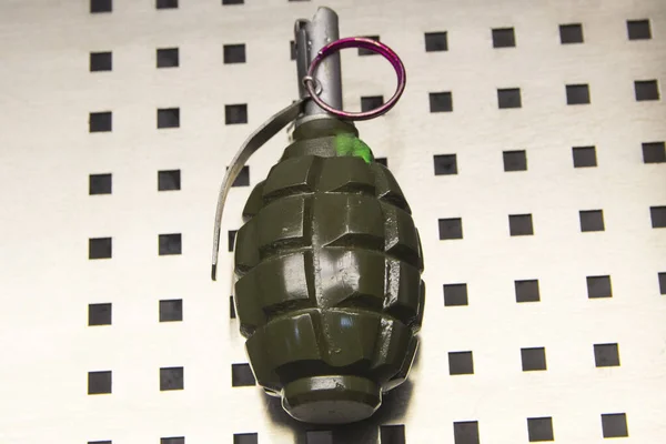 Fragmentation, combat grenade in green color close-up.