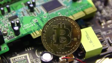 Cryptocurrency bitcoin lies on a microcircuit close-up.