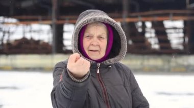 Grandmother, an elderly woman shows a fuck you close-up.