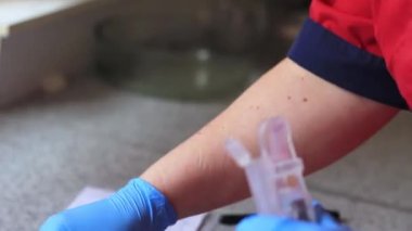 Eldiven giymiş bir kadın, DNA testi için bir sonda yerleştirir..