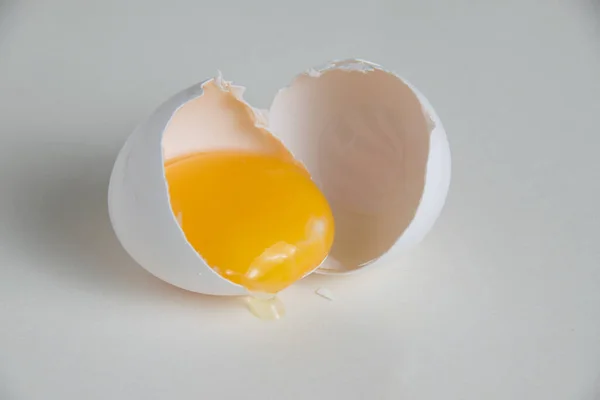 Egg yolk in the shell isolate on a white background.