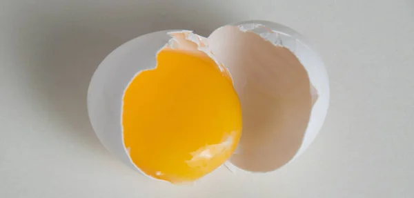 Egg yolk in the shell isolate on a white background.